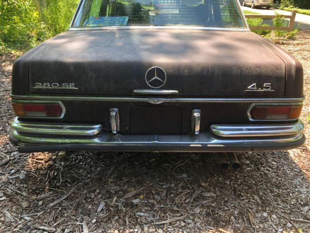 1973 maroon Mercedes-Benz 200-Series Sedan