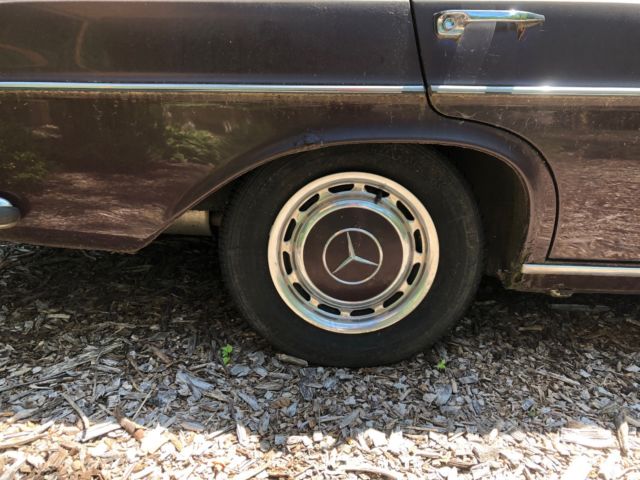 1973 maroon Mercedes-Benz 200-Series Sedan