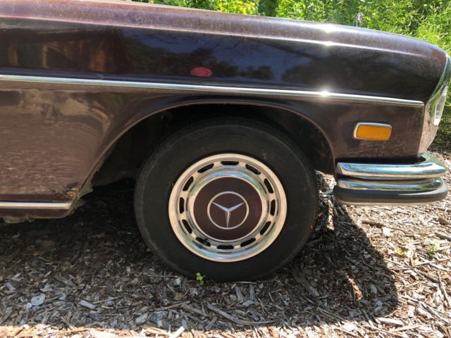 1973 maroon Mercedes-Benz 200-Series Sedan