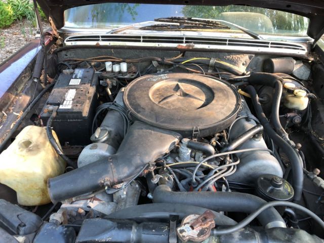 1973 maroon Mercedes-Benz 200-Series Sedan