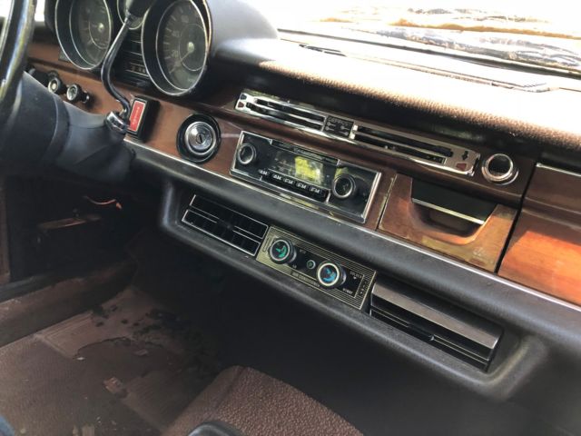 1973 maroon Mercedes-Benz 200-Series Sedan