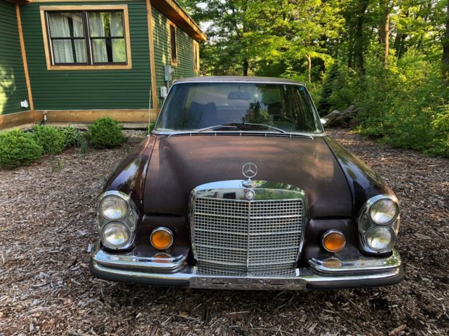 1973 maroon Mercedes-Benz 200-Series Sedan