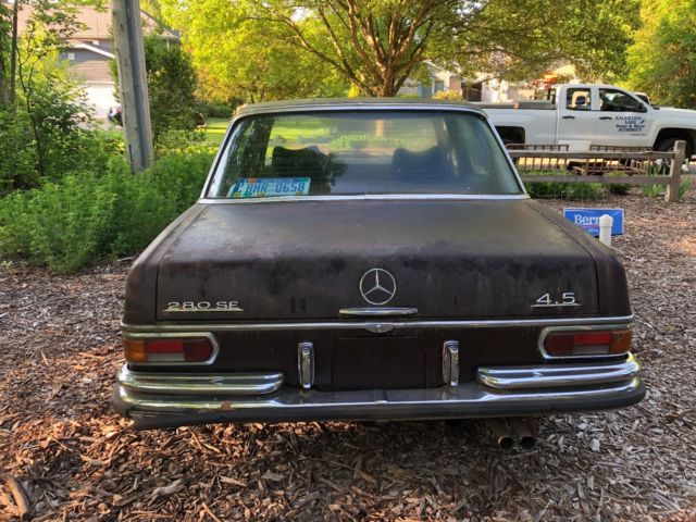 1973 maroon Mercedes-Benz 200-Series Sedan