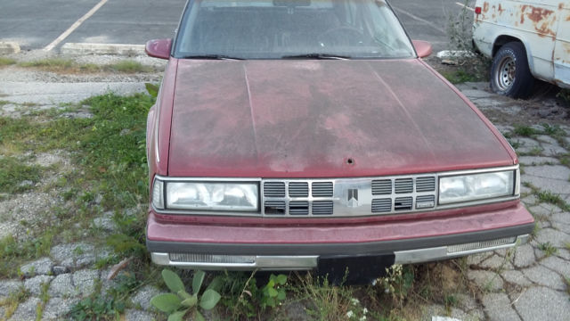 1990 Red Oldsmobile Ninety-Eight Sedan