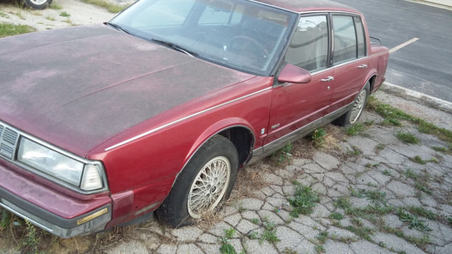 1990 Red Oldsmobile Ninety-Eight Sedan