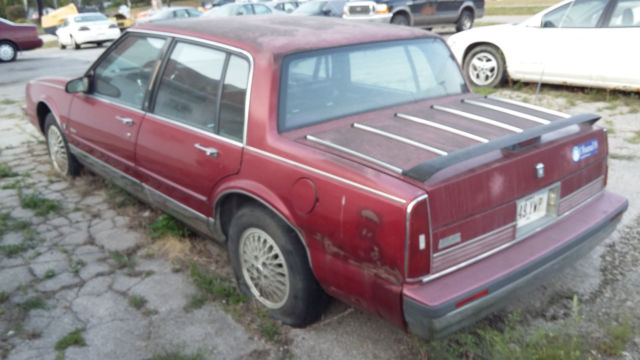 1990 Red Oldsmobile Ninety-Eight Sedan