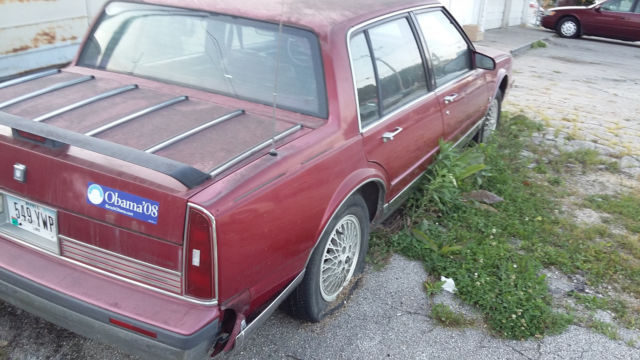 1990 Red Oldsmobile Ninety-Eight Sedan