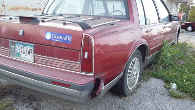1990 Red Oldsmobile Ninety-Eight Sedan
