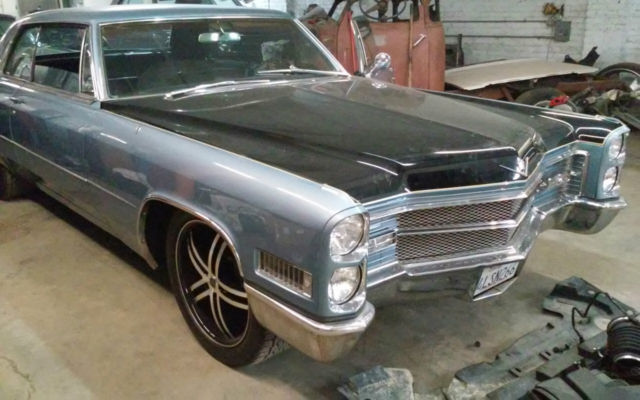 1966 Blue, Black,and a line of yellow Cadillac DeVille Coupe