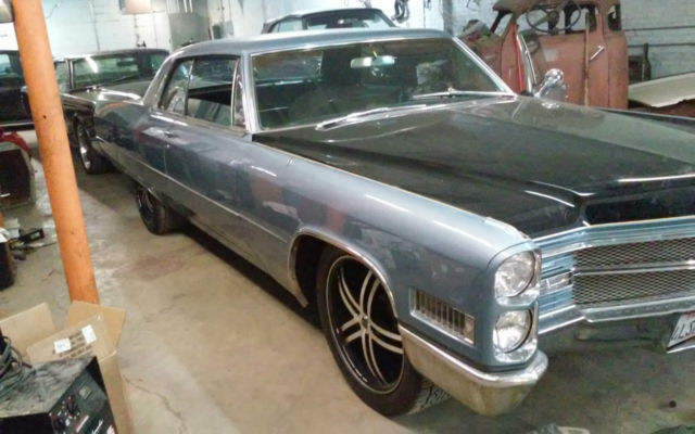1966 Blue, Black,and a line of yellow Cadillac DeVille Coupe