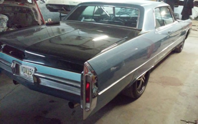 1966 Blue, Black,and a line of yellow Cadillac DeVille Coupe