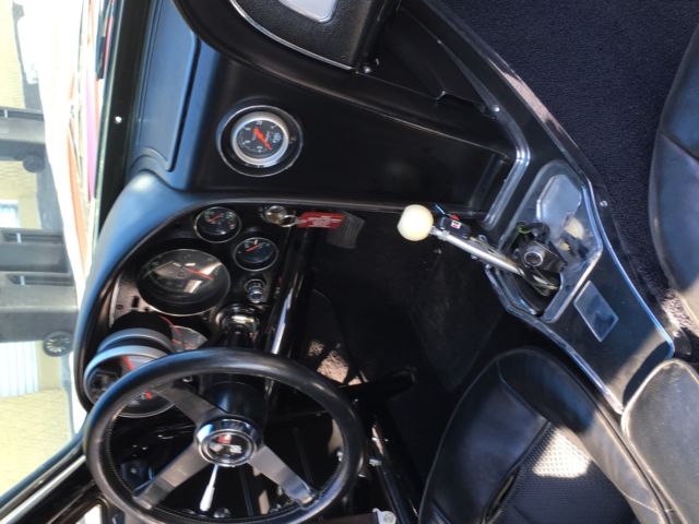 1965 maroon Chevrolet Corvette Coupe