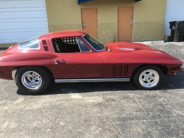 1965 maroon Chevrolet Corvette Coupe