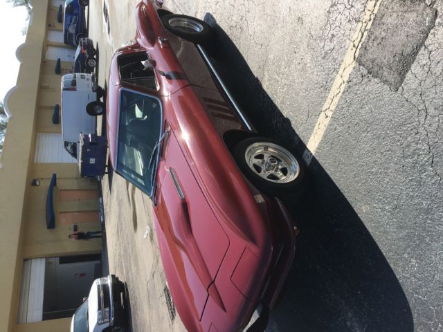 1965 maroon Chevrolet Corvette Coupe