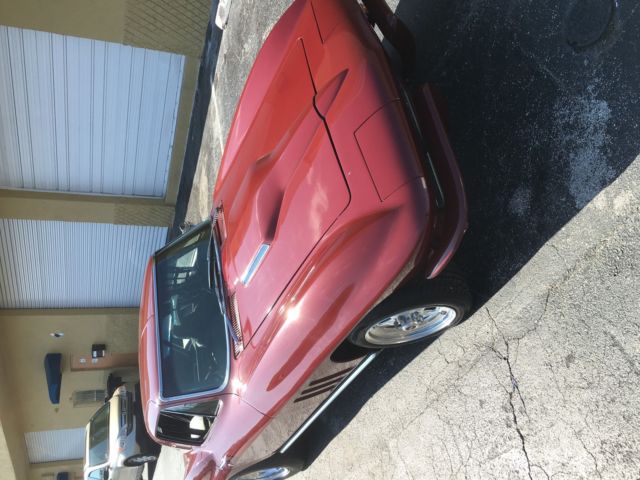 1965 maroon Chevrolet Corvette Coupe