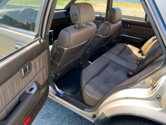 1987 Gold Nissan Maxima 4 door sports car