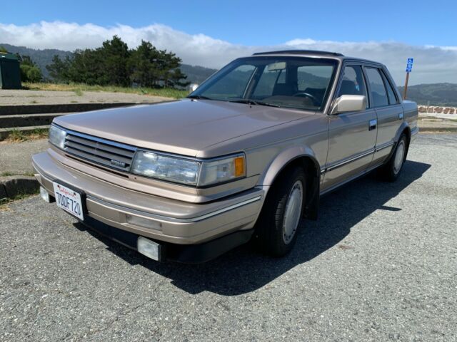 1987 Gold Nissan Maxima 4 door sports car