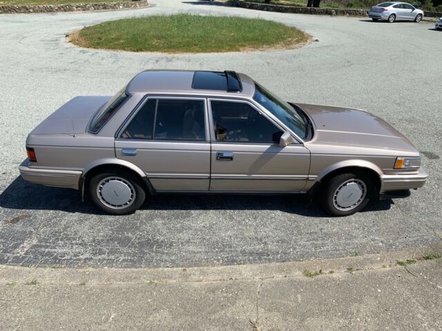 1987 Gold Nissan Maxima 4 door sports car
