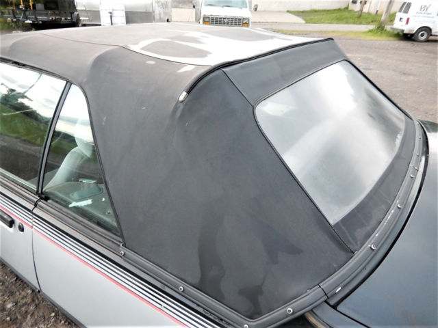 1986 Black/Silver Pontiac Sunbird Convertible