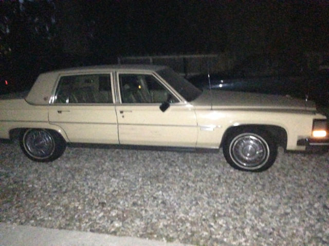 19820000 yellow Cadillac Brougham 4 door