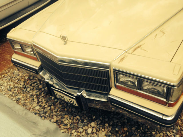 19820000 yellow Cadillac Brougham 4 door