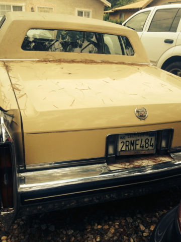 19820000 yellow Cadillac Brougham 4 door