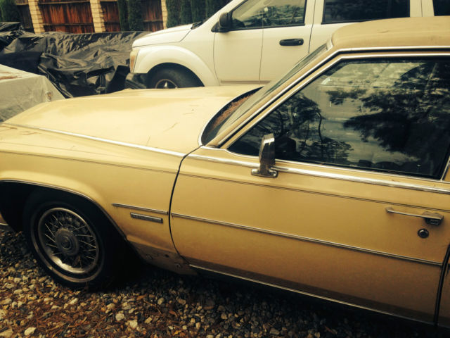 19820000 yellow Cadillac Brougham 4 door