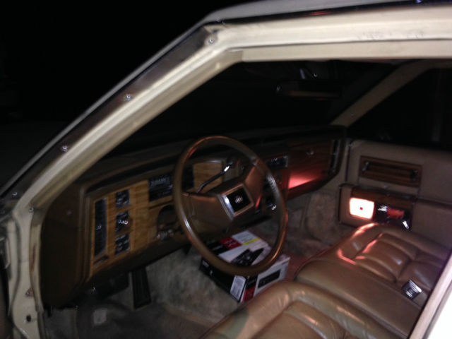 19820000 yellow Cadillac Brougham 4 door