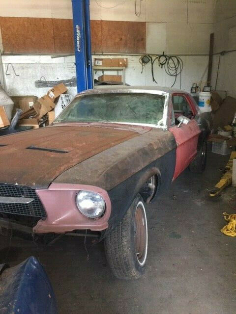 1968 primer red Ford Mustang Coupe
