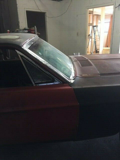 1968 primer red Ford Mustang Coupe