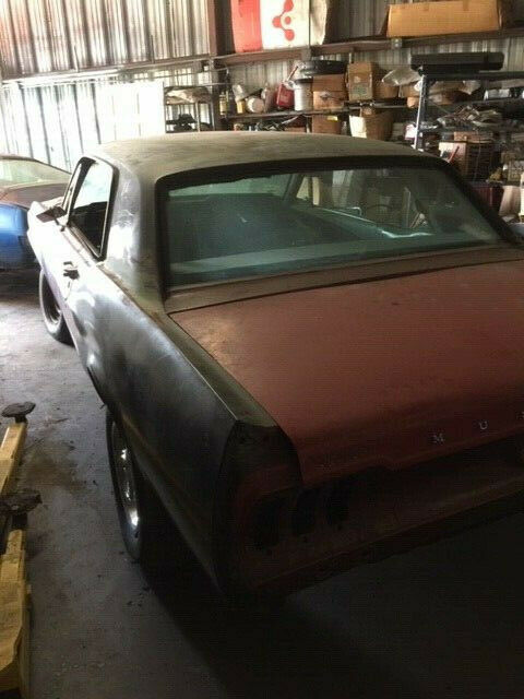 1968 primer red Ford Mustang Coupe