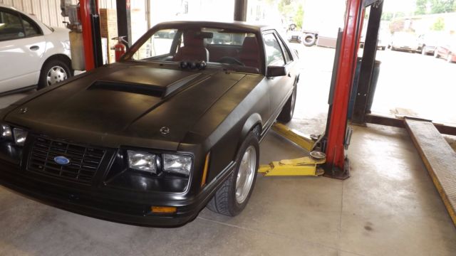 1984 flat black Ford Mustang Coupe