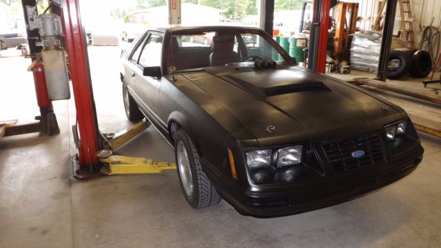 1984 flat black Ford Mustang Coupe