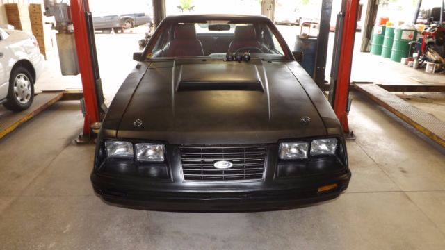 1984 flat black Ford Mustang Coupe
