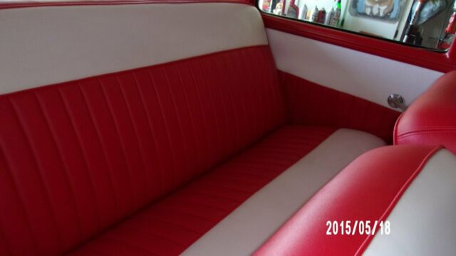 1957 red and white Ford Fairlane Coupe