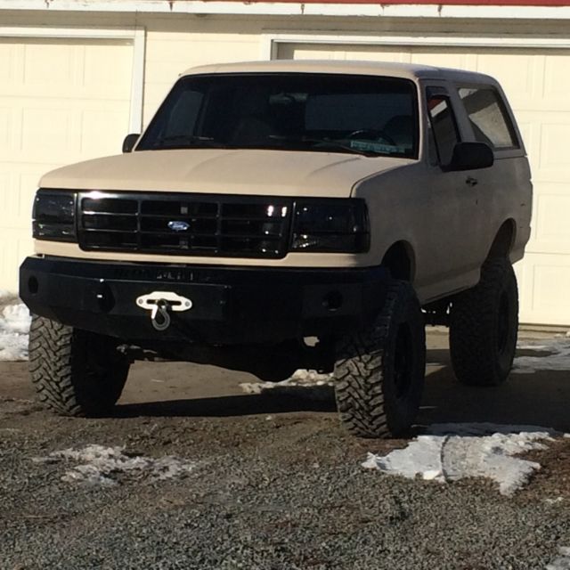 1993 tan bedlined Ford Bronco Convertible