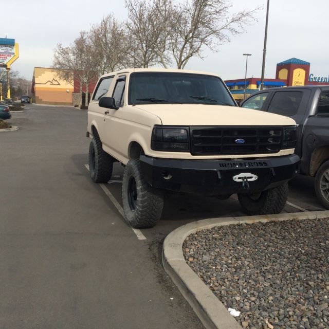1993 tan bedlined Ford Bronco Convertible