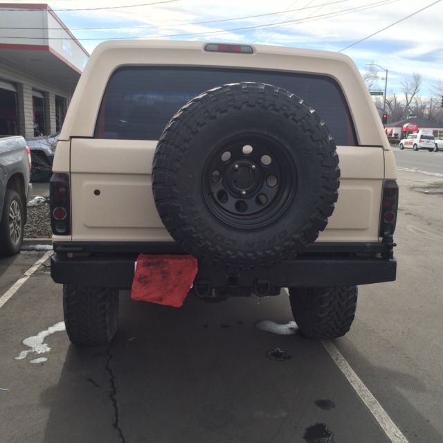 1993 tan bedlined Ford Bronco Convertible