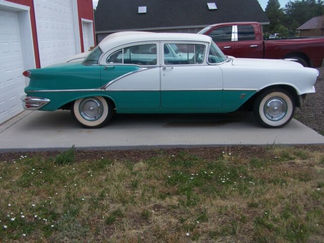 1956 green/white Oldsmobile Eighty-Eight four door sedan